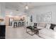 Bright, open-concept living area featuring modern decor, vaulted ceiling, and seamless flow to kitchen at 1351 N Pleasant Dr # 2051, Chandler, AZ 85225