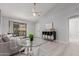 Bright, open-concept living area with a ceiling fan, seamless flow to dining area, and sliding door at 1351 N Pleasant Dr # 2051, Chandler, AZ 85225
