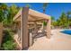 Community poolside BBQ with desert landscaping, palm trees, and lounge chairs at 1351 N Pleasant Dr # 2051, Chandler, AZ 85225