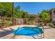 Relaxing community spa with a metal safety rail is surrounded by lush green landscaping at 1351 N Pleasant Dr # 2051, Chandler, AZ 85225