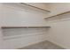Spacious walk-in closet featuring a minimalist hanging rod system at 1351 N Pleasant Dr # 2051, Chandler, AZ 85225