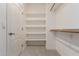Bright walk-in closet with built-in shelving and ample storage at 1351 N Pleasant Dr # 2051, Chandler, AZ 85225