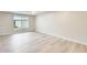 Bright bedroom with wood floors, baseboard molding, and a big window that allows lots of natural light at 13611 N 98Th Ave # D, Sun City, AZ 85351