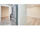 Hallway with a stainless steel refrigerator on one side and a view of a bright living space at 13611 N 98Th Ave # D, Sun City, AZ 85351