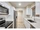 Bright kitchen featuring stainless steel appliances, quartz countertops and white cabinets at 13611 N 98Th Ave # D, Sun City, AZ 85351