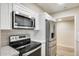 Updated kitchen featuring stainless steel appliances, white cabinets, and a subway tile backsplash at 13611 N 98Th Ave # D, Sun City, AZ 85351