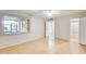 Spacious main bedroom with light wood floors, neutral walls, a large window, and ceiling fan at 13611 N 98Th Ave # D, Sun City, AZ 85351