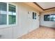 Enclosed patio area with decorative tile flooring, multiple windows, and neutral paint at 13611 N 98Th Ave # D, Sun City, AZ 85351