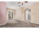 Standard sized bedroom with carpet, fan, and doorways to other parts of the house at 1367 S Country Club Dr # 1327, Mesa, AZ 85210