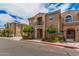 Attractive two-story home with balcony, mature trees, and colorful flower beds at 1367 S Country Club Dr # 1327, Mesa, AZ 85210