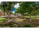 A serene grassy area with mature trees and a decorative drainage feature, offering a peaceful outdoor setting at 1367 S Country Club Dr # 1327, Mesa, AZ 85210