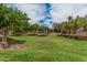 A spacious green lawn area with mature shade trees, offering a serene and peaceful outdoor environment at 1367 S Country Club Dr # 1327, Mesa, AZ 85210