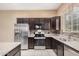 Modern kitchen featuring granite counters, stainless appliances, and dark cabinetry at 1367 S Country Club Dr # 1327, Mesa, AZ 85210