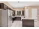Bright kitchen with granite countertops, stainless steel appliances and dark wood cabinets at 1367 S Country Club Dr # 1327, Mesa, AZ 85210