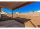 Expansive backyard with gravel landscaping and a covered patio area at 14352 W Lamoille Dr, Surprise, AZ 85374