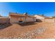 Large backyard with gravel landscaping, enclosed by block fencing, offering privacy and space at 14352 W Lamoille Dr, Surprise, AZ 85374