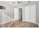 Bright bedroom featuring wood-look tile flooring and closet with sliding doors at 14352 W Lamoille Dr, Surprise, AZ 85374