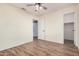 Bedroom with wood-look tile flooring, ceiling fan, and closet at 14352 W Lamoille Dr, Surprise, AZ 85374