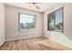 Bright bedroom featuring wood-look tile flooring, neutral walls, and a ceiling fan at 14352 W Lamoille Dr, Surprise, AZ 85374