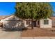 Charming single-story home featuring a well-maintained front yard and two-car garage at 14352 W Lamoille Dr, Surprise, AZ 85374