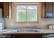 Close up on kitchen counter featuring stainless sink and an outside view at 14352 W Lamoille Dr, Surprise, AZ 85374