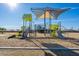 Community playground featuring a modern playset with slides and climbing structures at 14352 W Lamoille Dr, Surprise, AZ 85374