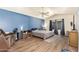 Bedroom with blue accent wall, ceiling fan and natural light from the window at 14390 W Morning Star Trl, Surprise, AZ 85374
