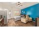 Bedroom featuring furniture, accent wall, ceiling fan, and door to exterior at 14390 W Morning Star Trl, Surprise, AZ 85374