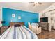Bedroom featuring accent wall, queen bed, ceiling fan, and TV at 14390 W Morning Star Trl, Surprise, AZ 85374