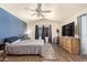 Bedroom with blue accent wall, ceiling fan and natural light from the window at 14390 W Morning Star Trl, Surprise, AZ 85374