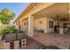 Large covered patio featuring a tiled floor, outdoor seating, and views of the landscaped backyard at 14390 W Morning Star Trl, Surprise, AZ 85374