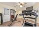 Home exercise room featuring a treadmill and weightlifting equipment with a ceiling fan and wood-look flooring at 14390 W Morning Star Trl, Surprise, AZ 85374