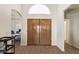 Spacious foyer featuring wood-look flooring, double front doors, and an arched doorway to an office at 14390 W Morning Star Trl, Surprise, AZ 85374