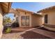 View of the front entrance with security door and desert landscaping at 14390 W Morning Star Trl, Surprise, AZ 85374