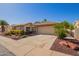 Charming single-story home featuring desert landscaping and an attached two-car garage at 14390 W Morning Star Trl, Surprise, AZ 85374
