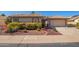 Charming single-story home featuring a tile roof, desert landscaping, and an attached two-car garage at 14390 W Morning Star Trl, Surprise, AZ 85374