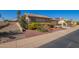 View of the house with desert landscaping, tile roof, and an attached two-car garage at 14390 W Morning Star Trl, Surprise, AZ 85374