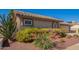 Close up view of desert landscaping and the front of the house with tile roof at 14390 W Morning Star Trl, Surprise, AZ 85374