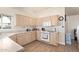 This kitchen features wooden floors, white cabinets, and natural light at 14390 W Morning Star Trl, Surprise, AZ 85374