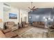 Spacious living room featuring high ceilings, ceiling fans, and an open floor plan at 14390 W Morning Star Trl, Surprise, AZ 85374