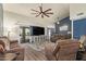 Spacious living room with high ceilings, a ceiling fan, and sliding glass doors to the backyard at 14390 W Morning Star Trl, Surprise, AZ 85374