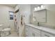 Bathroom boasts a modern vanity with marble countertops and shower with curtain at 1444 E Coronado Rd, Phoenix, AZ 85006