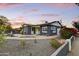 Charming home with a dark blue exterior, inviting front porch, and delightful landscape at 1444 E Coronado Rd, Phoenix, AZ 85006