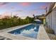 Backyard swimming pool with travertine surround, lush landscaping, perfect for relaxing outdoors at 1444 E Coronado Rd, Phoenix, AZ 85006