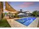 Beautiful backyard with a pool and patio furniture under a canvas shade at 1444 E Coronado Rd, Phoenix, AZ 85006
