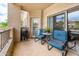 This tiled balcony features an outdoor grill and comfortable seating for enjoying the outside at 14950 W Mountain View Blvd # 7209, Surprise, AZ 85374