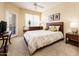 Inviting bedroom with a comfortable bed, carpet flooring, and neutral tones at 14950 W Mountain View Blvd # 7209, Surprise, AZ 85374