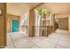 Inviting exterior showcasing a courtyard with a palm tree and a secured entrance door at 14950 W Mountain View Blvd # 7209, Surprise, AZ 85374