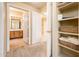 Hallway with built-in shelving and access to bathroom at 14950 W Mountain View Blvd # 7209, Surprise, AZ 85374