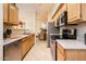 Efficient kitchen with sleek appliances and ample counter space, seamlessly connected to dining at 14950 W Mountain View Blvd # 7209, Surprise, AZ 85374